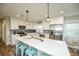 Bright and modern kitchen features stainless steel appliances, a large island, and contemporary pendant lighting at 102 & 104 48Th St, Holmes Beach, FL 34217