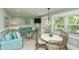Inviting living room and dining area with stylish furnishings, a decorative chandelier, and ample natural light at 102 & 104 48Th St, Holmes Beach, FL 34217