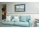 This beautifully decorated light blue couch features themed throw pillows and an ornate painting at 102 & 104 48Th St, Holmes Beach, FL 34217