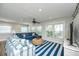 Bright living room boasts striped rug, comfortable seating, and natural light from large windows at 102 & 104 48Th St, Holmes Beach, FL 34217