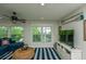 Spacious living area with bright windows, ceiling fan, and cozy furnishings at 102 & 104 48Th St, Holmes Beach, FL 34217