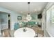 Cozy living room with two sofas and coastal decor, complemented by a dining area with seating for four at 102 & 104 48Th St, Holmes Beach, FL 34217