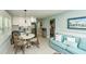 This cozy living room features a full kitchen, dining area, and comfortable light blue couch at 102 & 104 48Th St, Holmes Beach, FL 34217