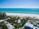 Beautiful aerial shot of a coastal community with beach access, lush greenery, and turquoise waters at 102 & 104 48Th St, Holmes Beach, FL 34217