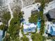 Breathtaking aerial view of a beachfront property with a pool, lush landscaping, and beach access at 102 & 104 48Th St, Holmes Beach, FL 34217