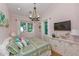 Cozy bedroom with pink walls, a patterned quilt, and natural light at 102 48Th St, Holmes Beach, FL 34217