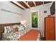 Comfortable bedroom with wooden ceiling beams, nautical decor, and natural light at 102 & 104 48Th St, Holmes Beach, FL 34217