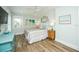 Bright bedroom featuring wood-look floors, ceiling fan and coastal decor at 102 & 104 48Th St, Holmes Beach, FL 34217
