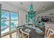 Dining area with view of beach, equipped with stylish decor and blue chandelier at 102 48Th St, Holmes Beach, FL 34217