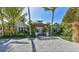 Charming coastal home with a trellis entry, tropical landscaping, and a serene beach vibe at 102 & 104 48Th St, Holmes Beach, FL 34217