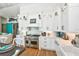 Modern kitchen with white cabinetry, stainless steel appliances, and a tiled backsplash at 102 & 104 48Th St, Holmes Beach, FL 34217