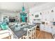 Open-concept kitchen and dining area with a statement chandelier and coastal accents at 102 & 104 48Th St, Holmes Beach, FL 34217