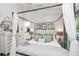 Relaxing main bedroom with white walls, a four-poster bed, and beachy accents at 102 & 104 48Th St, Holmes Beach, FL 34217