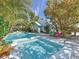 Inviting backyard with a pool, spa, lounge chairs, and lush tropical landscaping creating a private oasis at 102 & 104 48Th St, Holmes Beach, FL 34217