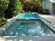 Relaxing pool and spa area with a spa, lush landscaping, and a tranquil backyard setting at 102 & 104 48Th St, Holmes Beach, FL 34217