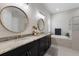 Bathroom featuring double sinks, modern lighting, a soaking tub, and a glass-enclosed shower at 11513 11Th E Ave, Bradenton, FL 34212