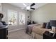 Neutral bedroom with two shuttered windows allowing natural light to pour in and a ceiling fan to keep it cool at 11513 11Th E Ave, Bradenton, FL 34212