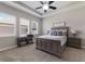 Bedroom with neutral colors, tray ceiling, plantation shutters, and furnishings including a desk and nightstands at 11513 11Th E Ave, Bradenton, FL 34212