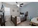Bedroom with hardwood furniture, a modern ceiling fan, and decorative shelves at 11513 11Th E Ave, Bradenton, FL 34212