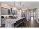 Modern kitchen features gray cabinets, stainless steel appliances, an island with a marble countertop, and pendant lighting at 11513 11Th E Ave, Bradenton, FL 34212