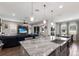 Open floor plan featuring a kitchen with a large island and a stainless steel sink that overlooks the living and dining areas at 11513 11Th E Ave, Bradenton, FL 34212