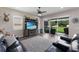 Relaxing living room with a TV, large sofa, view of the backyard, and access to the outdoor patio area at 11513 11Th E Ave, Bradenton, FL 34212