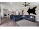 Open floor plan showcasing the kitchen and living room with wood-look flooring and large blue sectional sofa at 11513 11Th E Ave, Bradenton, FL 34212