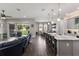Open-concept space with a kitchen island, dining area, and sliding glass doors to the outdoor space at 11513 11Th E Ave, Bradenton, FL 34212