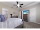 Main bedroom with tray ceiling, ceiling fan, neutral colors, ensuite bath access, and a television at 11513 11Th E Ave, Bradenton, FL 34212