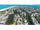 Stunning aerial view of a coastal neighborhood with lush greenery and waterfront access, highlighting luxurious living at 120 Hammock Rd, Anna Maria, FL 34216