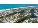 Breathtaking aerial view of homes nestled among waterways near a pristine beach, showcasing an idyllic coastal community at 120 Hammock Rd, Anna Maria, FL 34216