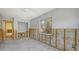 Bedroom under renovation features a large window, cement walls, and unfinished flooring at 120 Hammock Rd, Anna Maria, FL 34216
