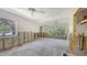 Bright living room with large windows offering outdoor views, ceiling fans, and a spacious layout ready for renovation at 120 Hammock Rd, Anna Maria, FL 34216