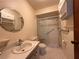 Bright bathroom featuring a walk-in shower with grab bars, ample lighting and neutral color palette at 1214 56Th W St # 1214, Bradenton, FL 34209