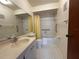 Clean bathroom features a vanity, toilet, and tiled shower with accessibility features at 1214 56Th W St # 1214, Bradenton, FL 34209