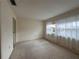 Vacant bedroom featuring a window, neutral carpeting, and a built-in closet at 1214 56Th W St # 1214, Bradenton, FL 34209