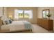 Tastefully staged bedroom with natural light, dresser, and comfortable furnishings at 1214 56Th W St # 1214, Bradenton, FL 34209
