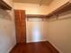 Walk-in closet features hardwood floors, built-in shelving, and ample storage space at 1214 56Th W St # 1214, Bradenton, FL 34209