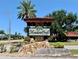 Attractive entrance sign for MeadowCroft community, surrounded by mature landscaping at 1214 56Th W St # 1214, Bradenton, FL 34209