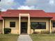 Inviting entrance to a villa with a red tile roof and neatly trimmed greenery at 1214 56Th W St # 1214, Bradenton, FL 34209