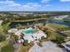 Aerial view of community pool, clubhouse, lake, and playground offer luxurious recreation options at 12339 Glenridge Ln, Parrish, FL 34219