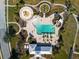 Aerial view of community pool, playground, and splashpad, creating a resort-style oasis at 12339 Glenridge Ln, Parrish, FL 34219