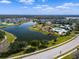 Community aerial view of a lake, with a community center, pool, and splash pad for recreation at 12339 Glenridge Ln, Parrish, FL 34219