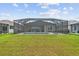 Large screened-in pool and patio with lounge chairs and views of the expansive backyard at 12339 Glenridge Ln, Parrish, FL 34219