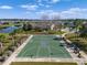 Community basketball court with mature trees and a lake creates a sports recreational area at 12339 Glenridge Ln, Parrish, FL 34219