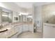 Spacious bathroom with granite countertops, double vanity, and large mirrors, next to walk-in shower at 12339 Glenridge Ln, Parrish, FL 34219