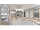 Elegant bathroom featuring granite counters, lots of mirrors and storage with an adjacent walk-in shower at 12339 Glenridge Ln, Parrish, FL 34219