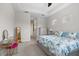 Light-filled bedroom with tray ceiling, carpet flooring and a makeup vanity next to large window at 12339 Glenridge Ln, Parrish, FL 34219