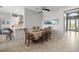 Dining area featuring a large table and chairs adjacent to the kitchen with a sunny window view at 12339 Glenridge Ln, Parrish, FL 34219