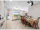 Dining area featuring a large table and chairs adjacent to a sunny living room and large screened windows at 12339 Glenridge Ln, Parrish, FL 34219